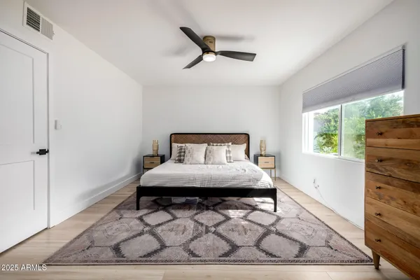 a bedroom with a bed and a window