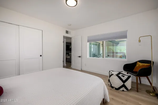 a view of a patio with couches table and chairs and potted plants