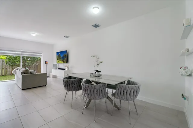 a dining room with furniture and wooden floor