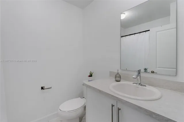 a bathroom with a sink toilet and a mirror