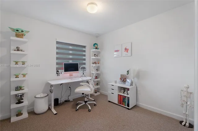 a room with a chair and white walls