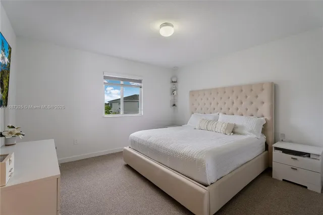 a bed room with a bed and a white wall