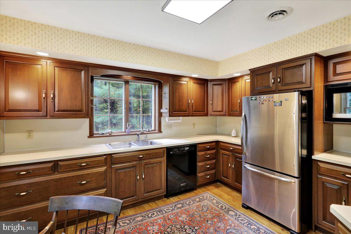 154 Deer Hill Road Reading, PA 19607 - Photo 23 of 97 a kitchen with stainless steel appliances granite countertop a refrigerator and a sink