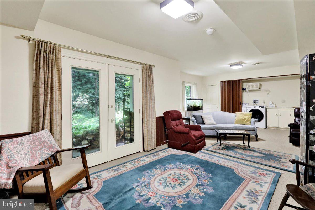 154 Deer Hill Road Reading, PA 19607 - Photo 50 of 97 a living room with furniture floor to ceiling window and wooden floor