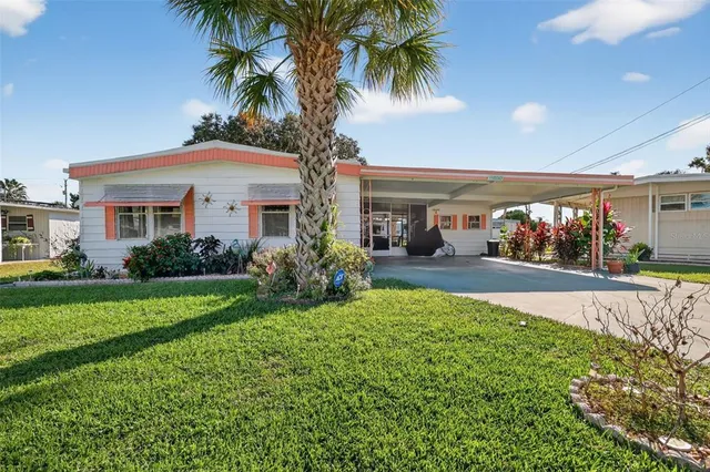 a front view of house with yard and outdoor seating