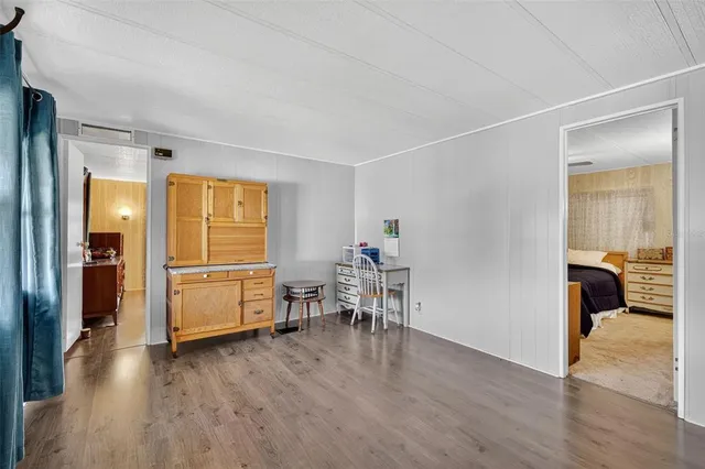 a view of a livingroom with furniture and hardwood floor