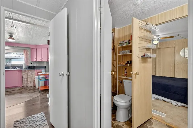 a bathroom with a granite countertop toilet a sink and a shower