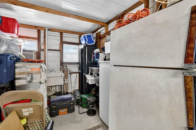 a utility room with lot of furniture and a shower