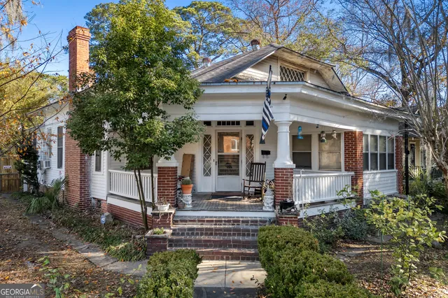a view of a house with a large windows and a small yard