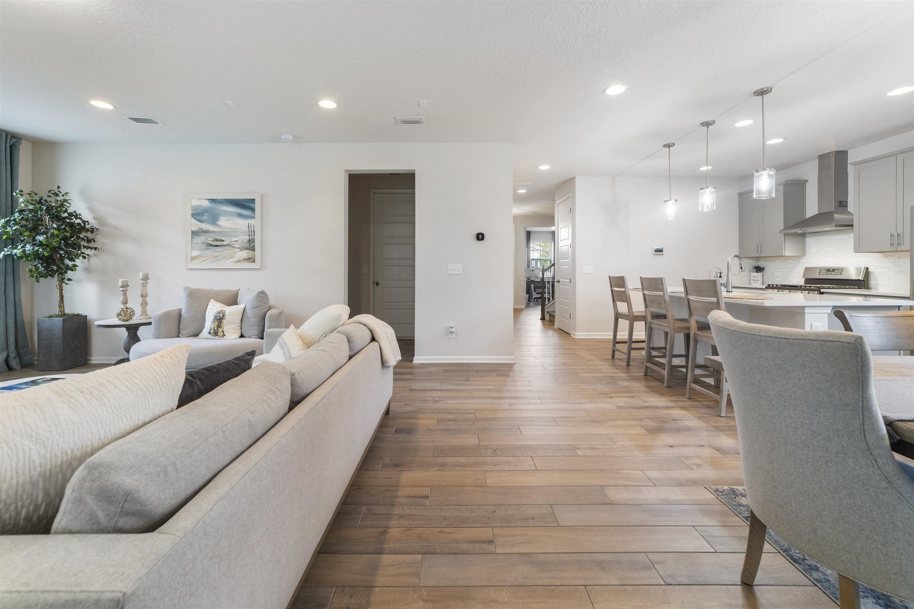 91 Pepperpike Way Street St. Augustine, FL 32092 - Photo 21 of 79 a living room with furniture and a dining table with kitchen view