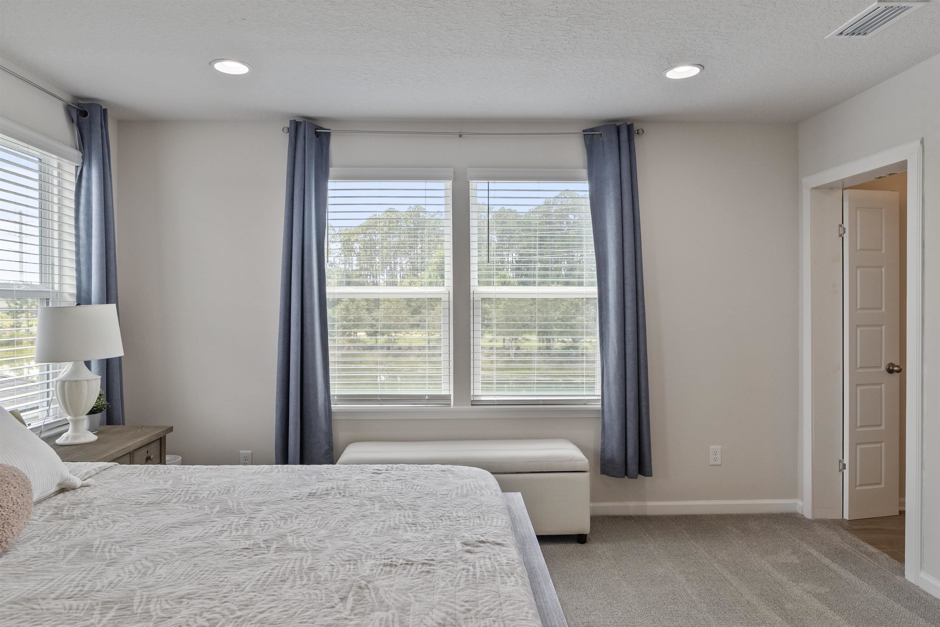 91 Pepperpike Way Street St. Augustine, FL 32092 - Photo 42 of 79 a spacious bedroom with a bed and a large window