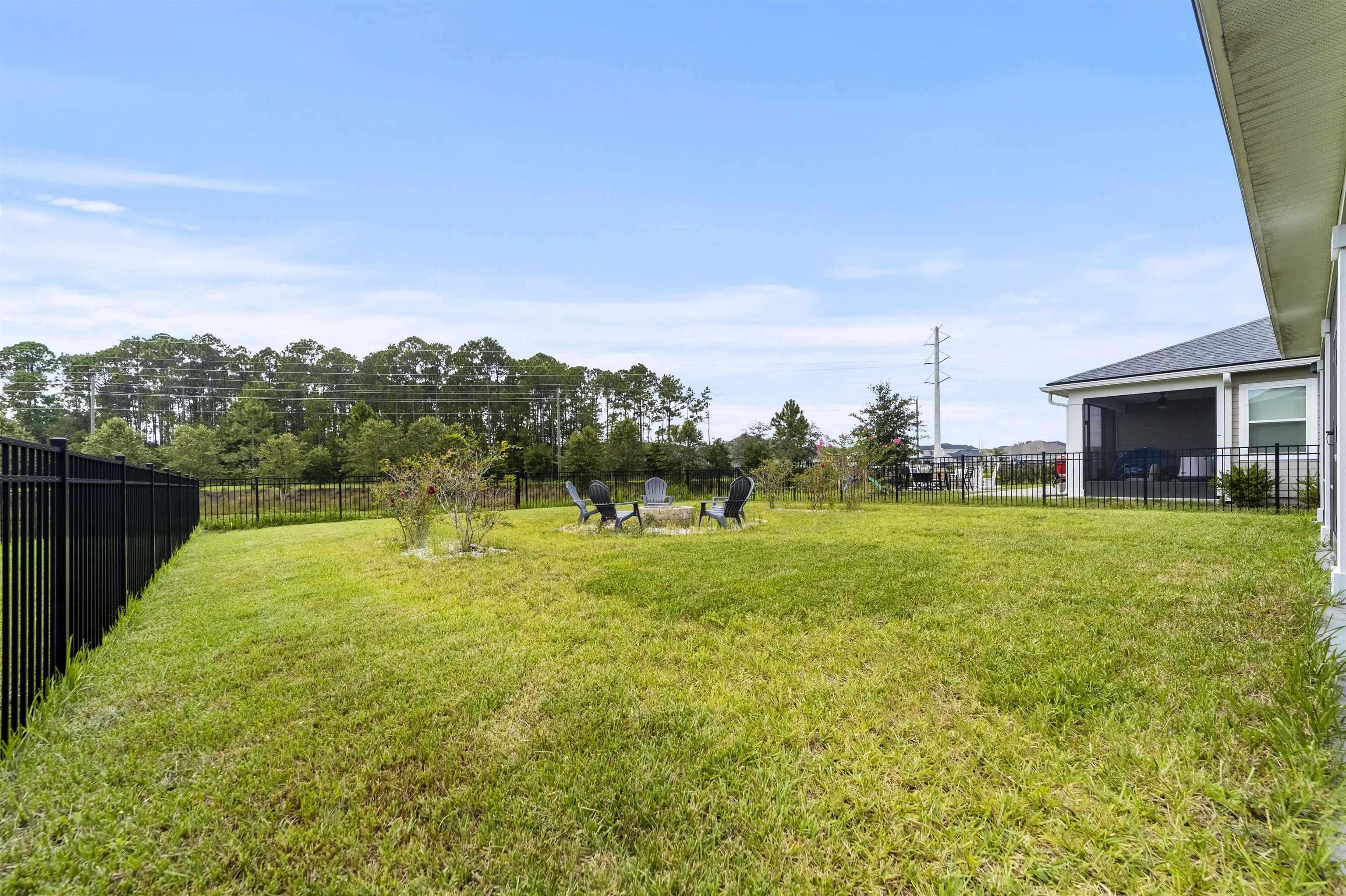 91 Pepperpike Way Street St. Augustine, FL 32092 - Photo 63 of 79 Fenced backyard with a fire pit