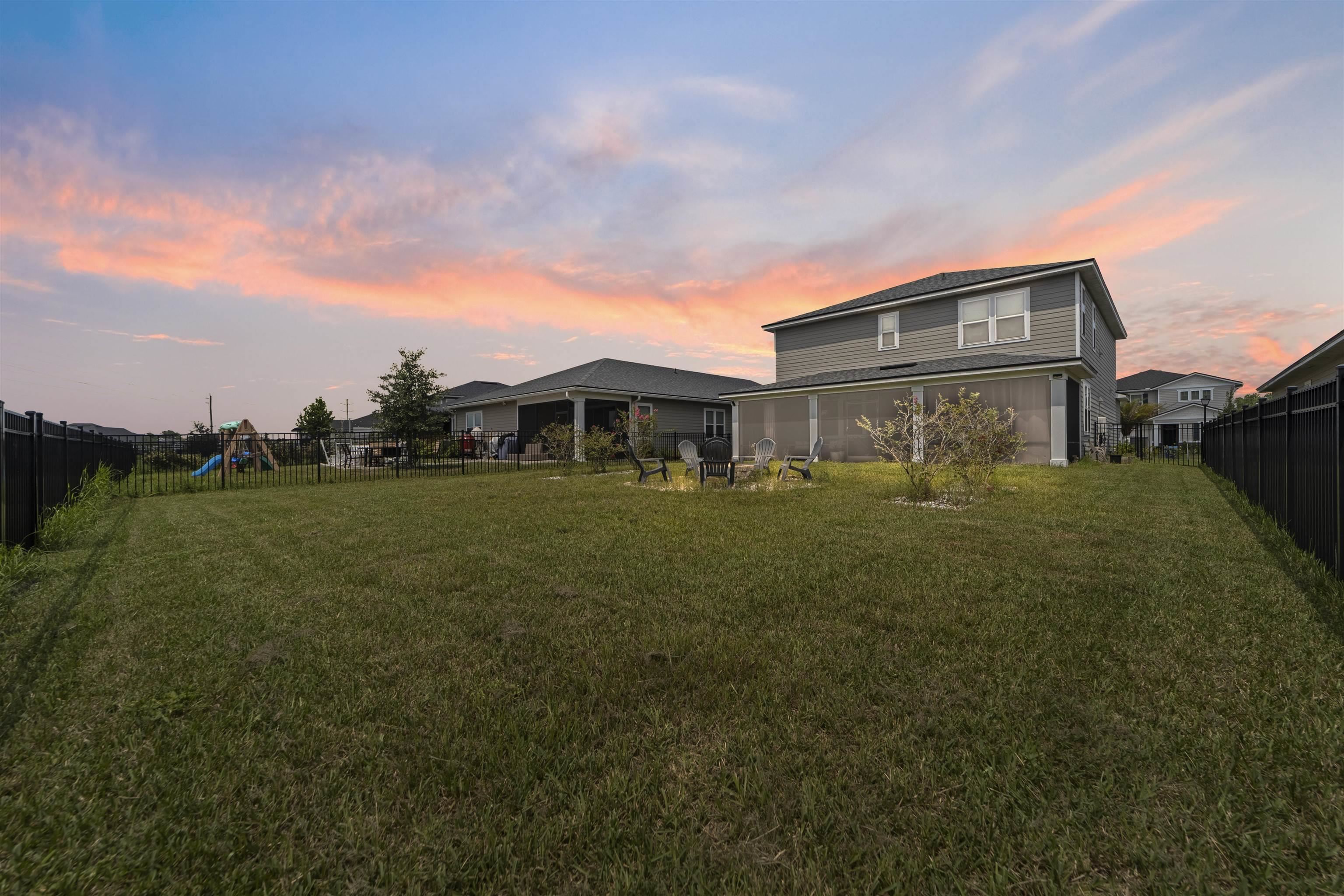 91 Pepperpike Way Street St. Augustine, FL 32092 - Photo 66 of 79 Rear view of house featuring a fenced backyard and a playground
