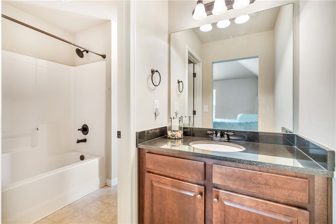 144 Buckland Drive Anderson, SC 29621 - Photo 23 of 48 A sleek vanity with dark counters complements the tub and shower combination, offering a clean, contemporary feel.