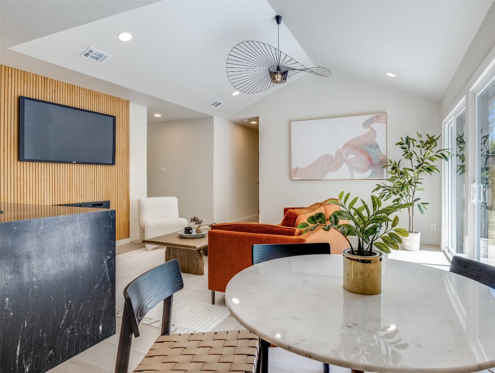 a dining room with furniture and a potted plant