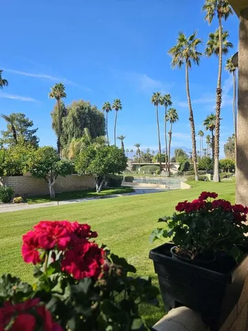 a view of a patio with a table and chairs under an umbrella