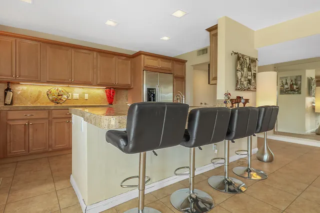 a kitchen with a dining table chairs and white cabinets