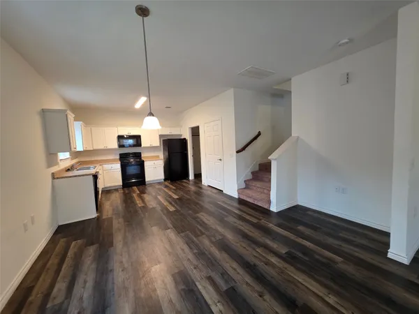 a view of kitchen and hall with wooden floor