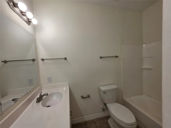 a bathroom with a granite countertop toilet a sink and shower