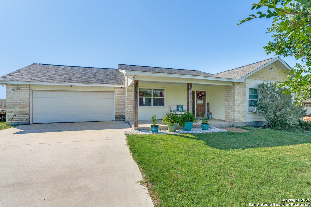 a front view of house with yard and outdoor seating