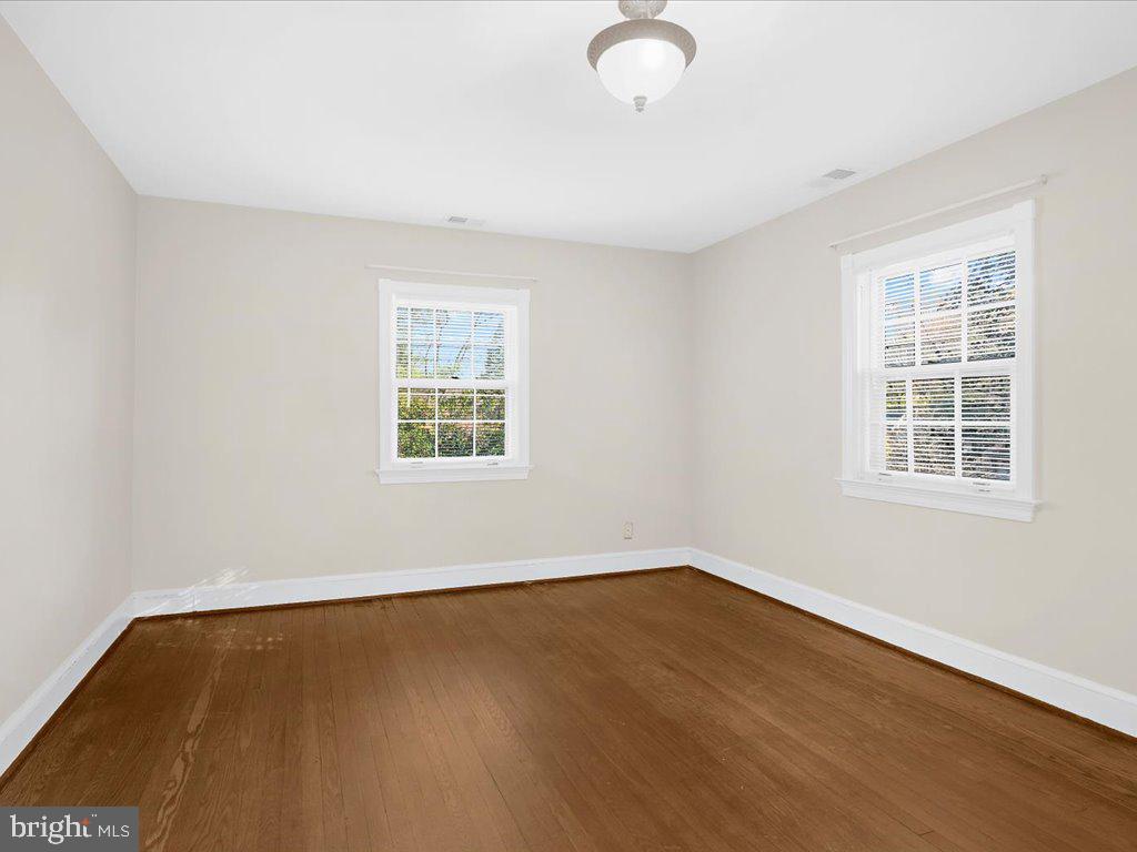1201 Noyes Drive Silver Spring, MD 20910 - Photo 16 of 35 an empty room with wooden floor and windows