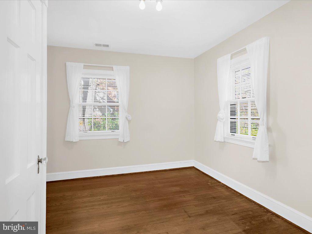 1201 Noyes Drive Silver Spring, MD 20910 - Photo 22 of 35 an empty room with wooden floor and windows