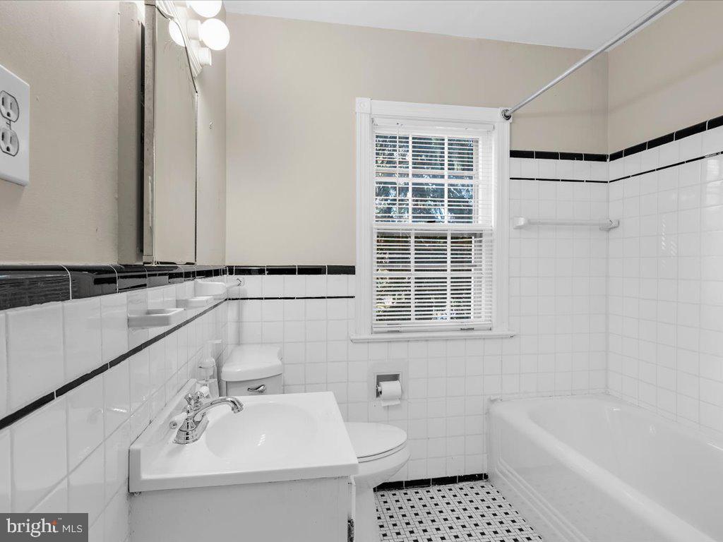 1201 Noyes Drive Silver Spring, MD 20910 - Photo 25 of 35 a bathroom with a sink a bathtub and a shower