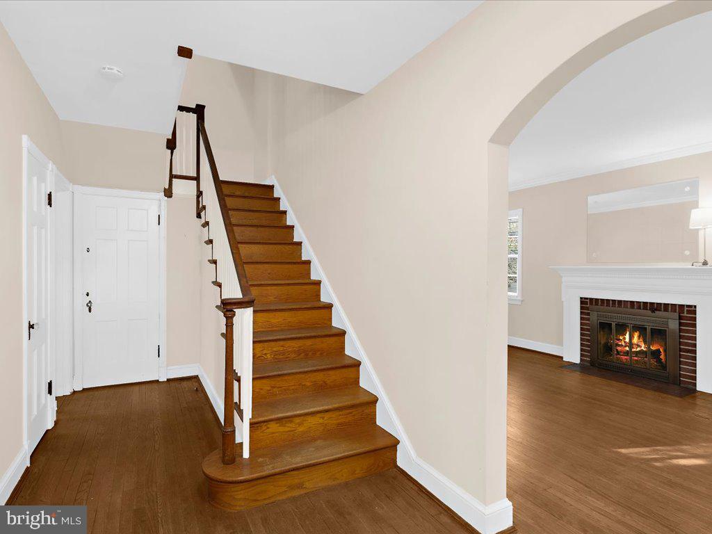 1201 Noyes Drive Silver Spring, MD 20910 - Photo 6 of 35 a view of an entryway with wooden floor and a fireplace