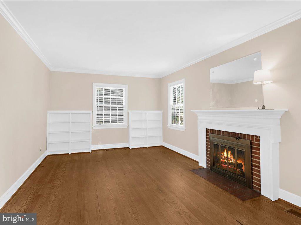 1201 Noyes Drive Silver Spring, MD 20910 - Photo 7 of 35 a view of an empty room with wooden floor fireplace and a window