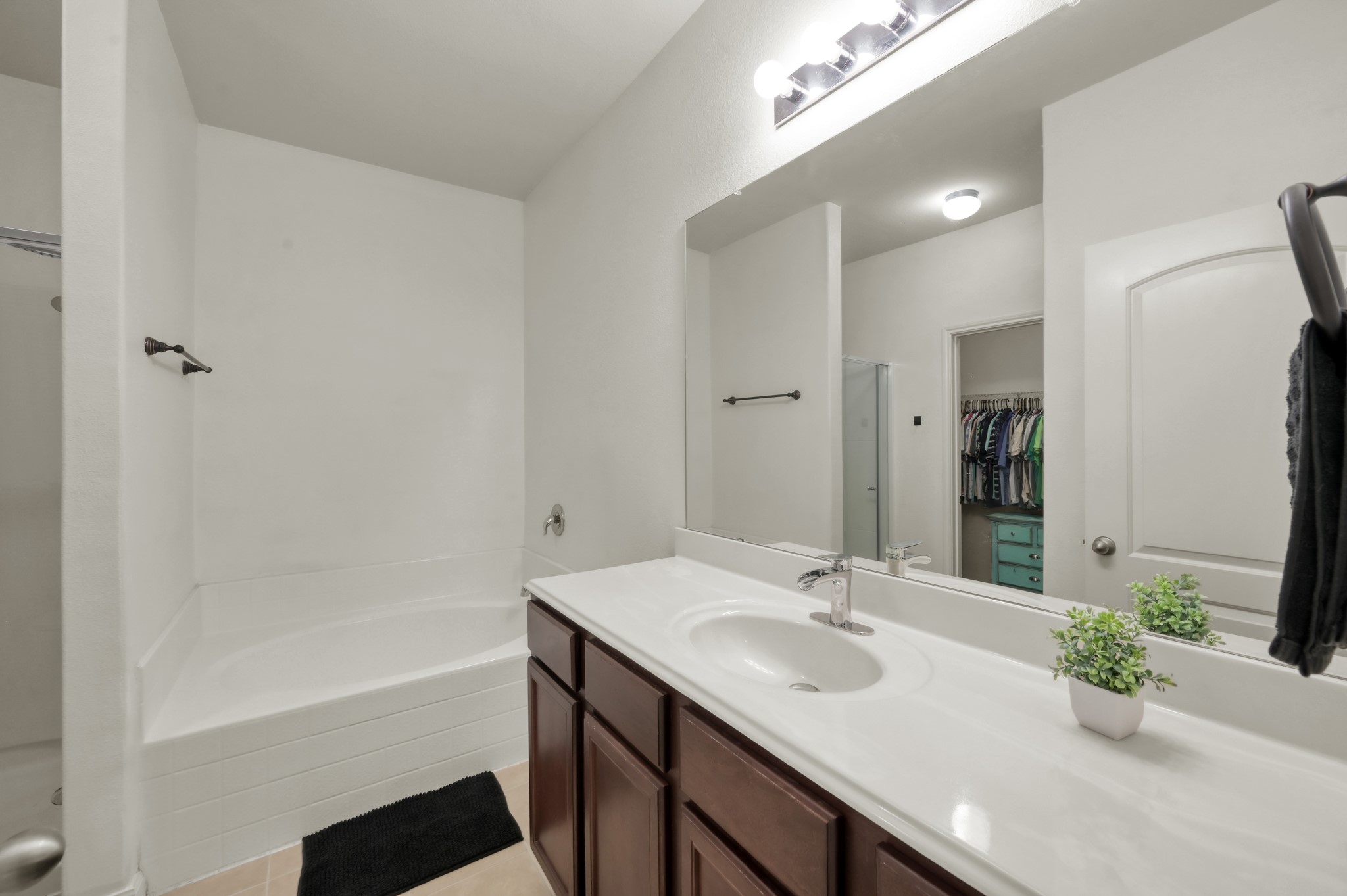 7562 Fettle Lane Conroe, TX 77304 - Photo 18 of 30 Well-appointed primary bathroom with extended vanity space, ample storage, and spacious walk-in closet.