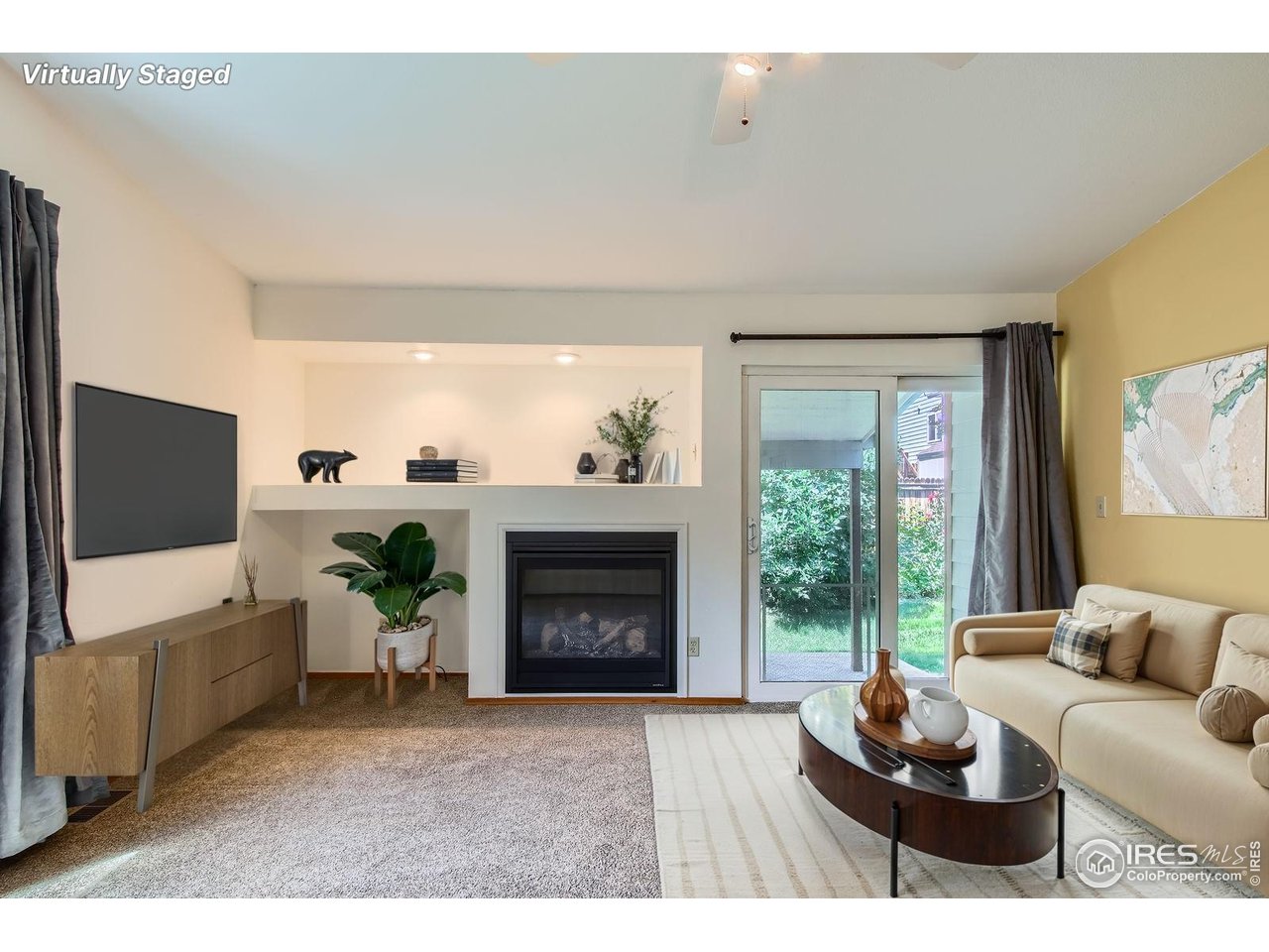 10947 West 100th Drive Broomfield, CO 80021 - Photo 11 of 38 a living room with furniture and a flat screen tv