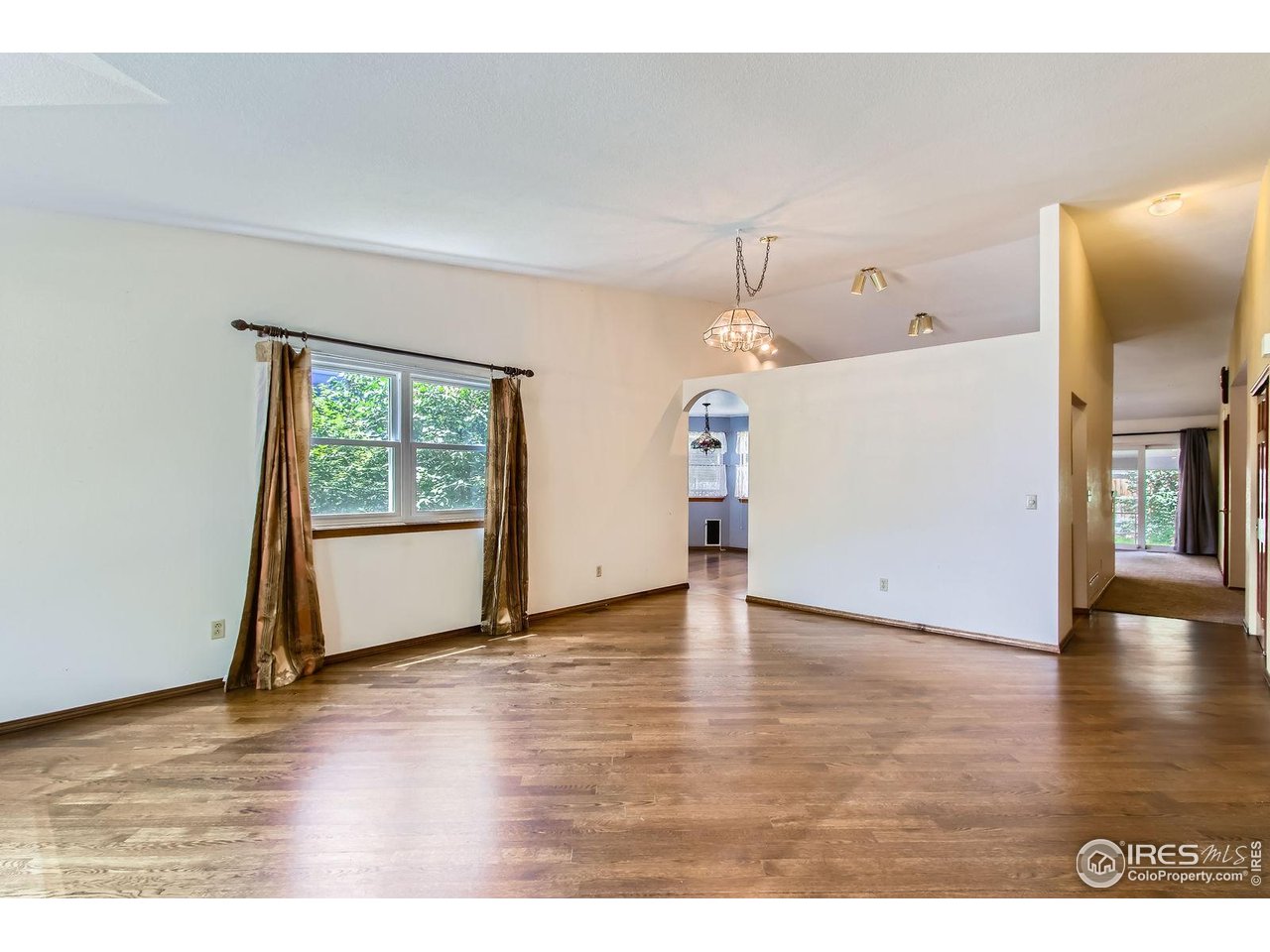 10947 West 100th Drive Broomfield, CO 80021 - Photo 17 of 38 a view of an empty room and wooden floor