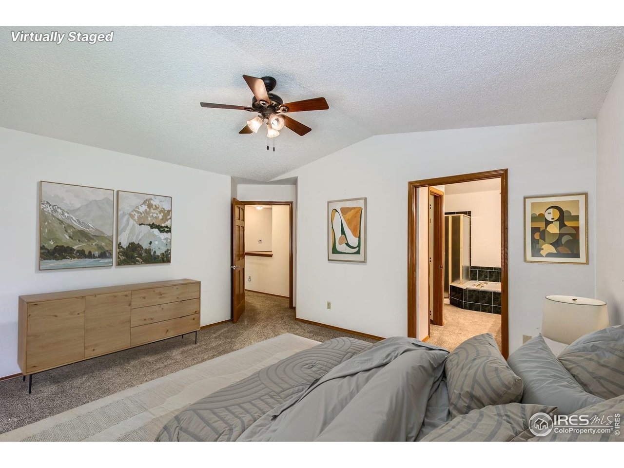 10947 West 100th Drive Broomfield, CO 80021 - Photo 21 of 38 a bedroom with a bed and a chandelier