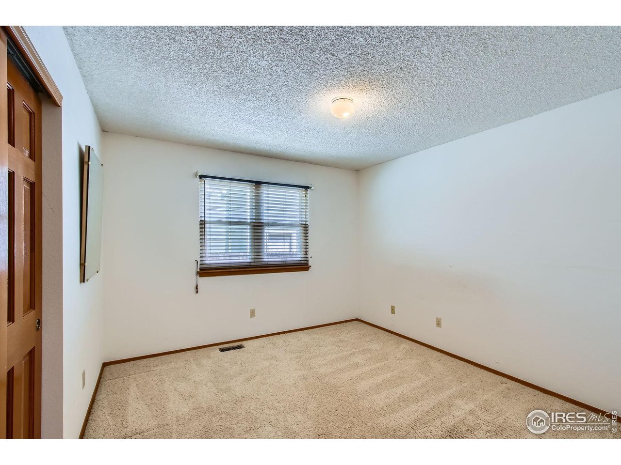 10947 West 100th Drive Broomfield, CO 80021 - Photo 25 of 38 a view of an empty room with a window