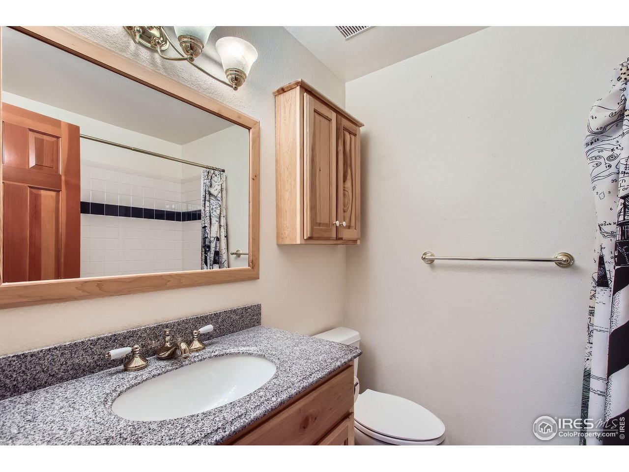 10947 West 100th Drive Broomfield, CO 80021 - Photo 26 of 38 a bathroom with a granite countertop sink a mirror and a toilet