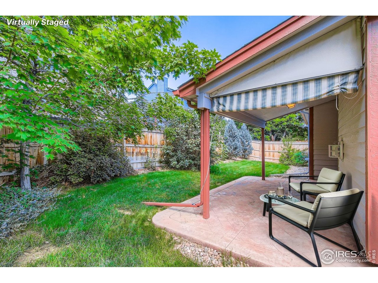 10947 West 100th Drive Broomfield, CO 80021 - Photo 27 of 38 a view of a patio with a table chairs and a yard