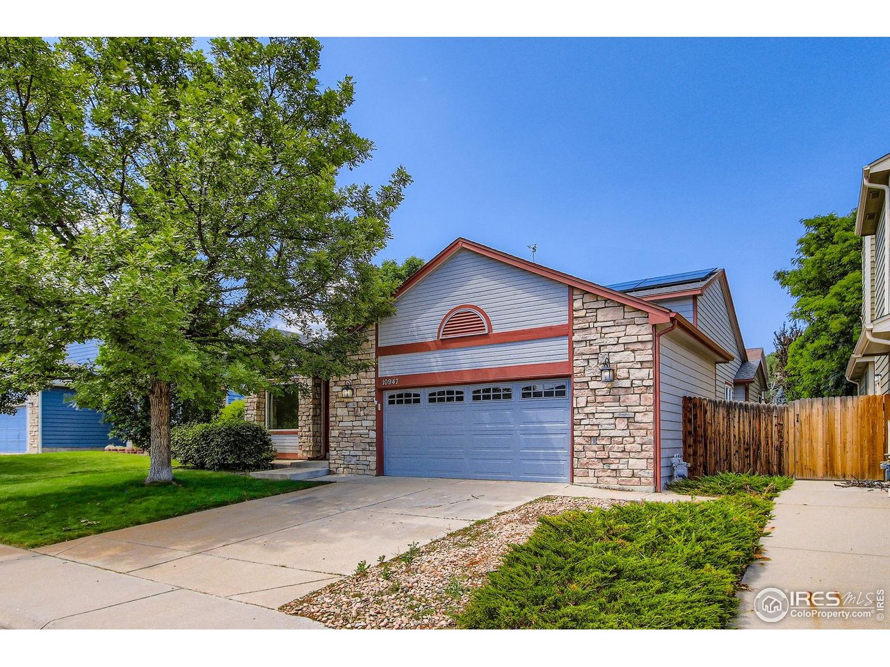 10947 West 100th Drive Broomfield, CO 80021 - Photo 34 of 38 a front view of a house with a yard and garage