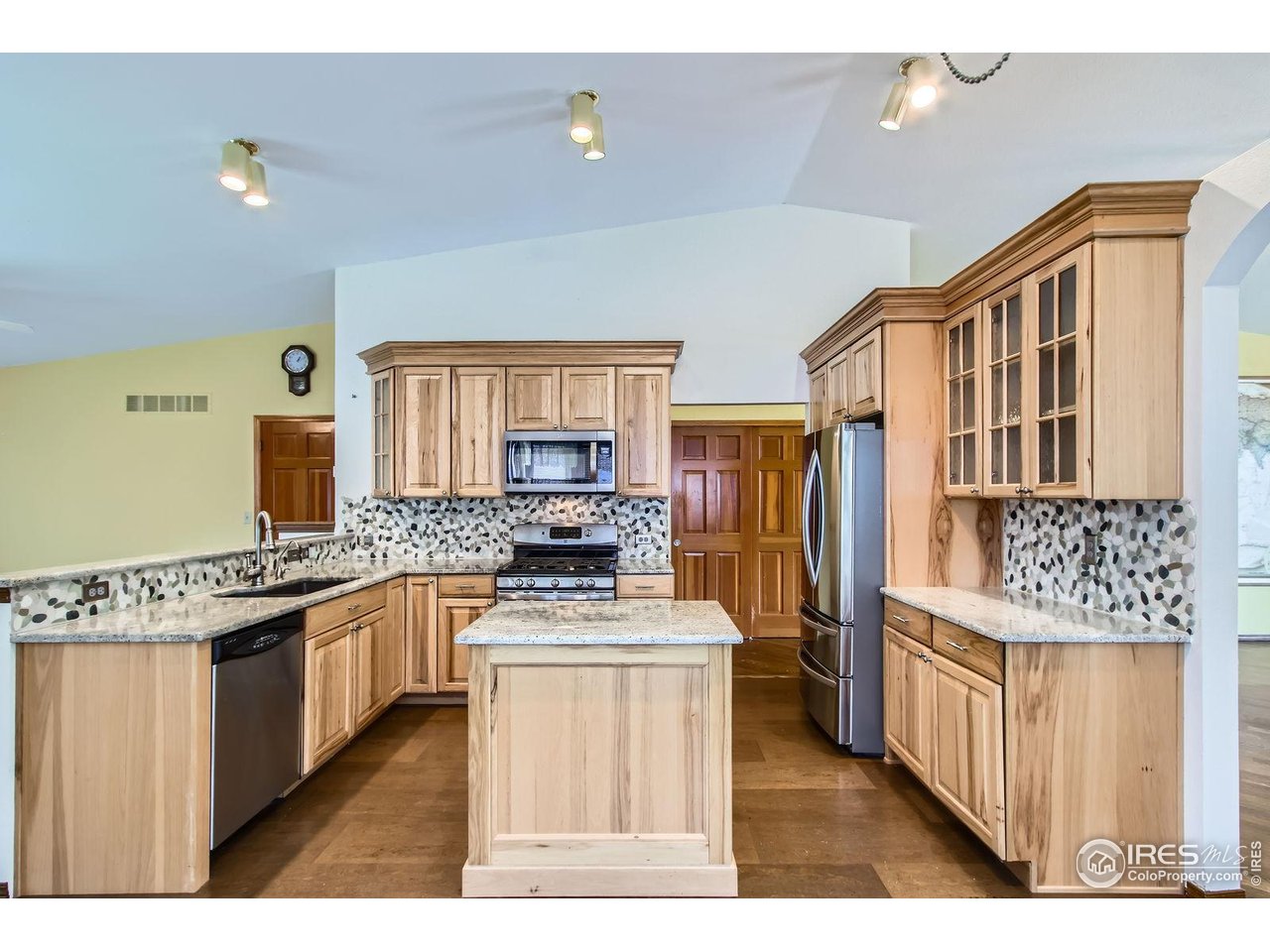 10947 West 100th Drive Broomfield, CO 80021 - Photo 6 of 38 a kitchen with stainless steel appliances granite countertop a stove top oven a sink a counter space and cabinets