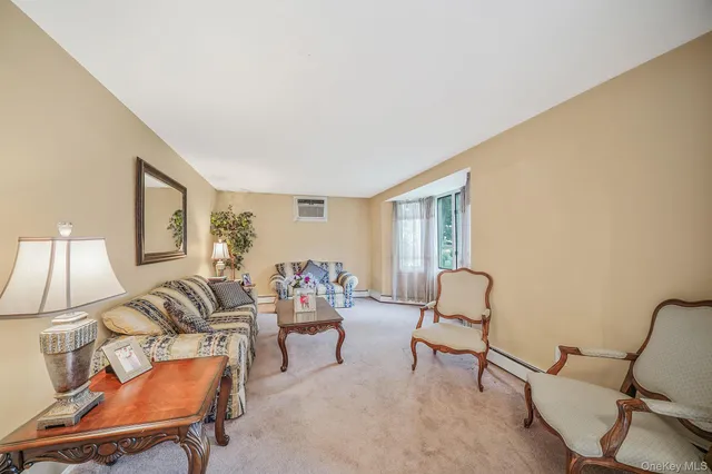 a living room with furniture and a lamp