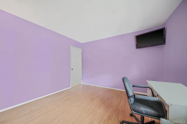 a workspace with a flat screen tv and chair
