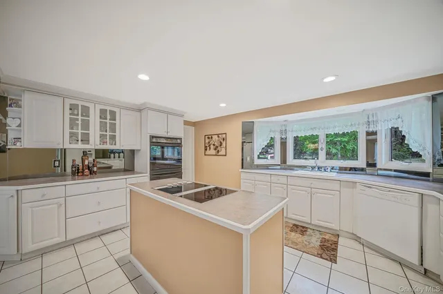 a kitchen that has a sink and a stove top oven