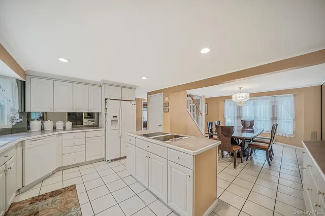 a kitchen with a sink and chairs
