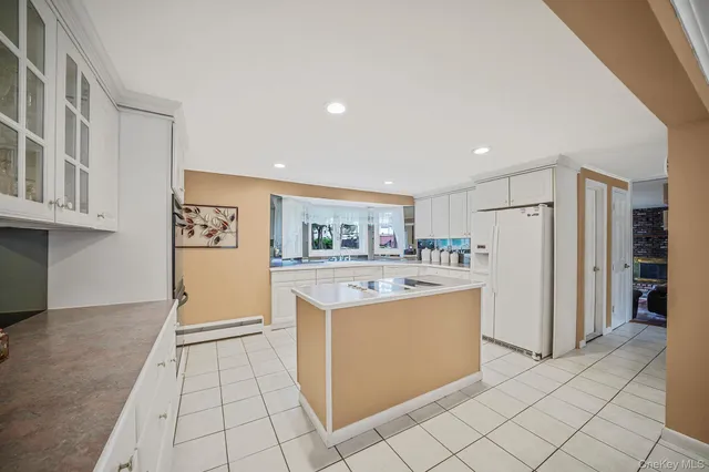 a kitchen with stainless steel appliances granite countertop a refrigerator and a stove