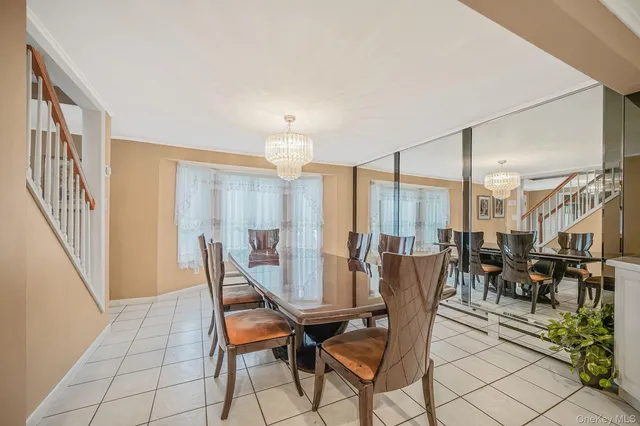 a dining room with furniture a chandelier and wooden floor