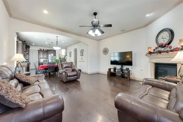 a living room with furniture a clock and a flat screen tv