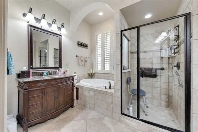 a bathroom with a double vanity sink a large mirror and shower