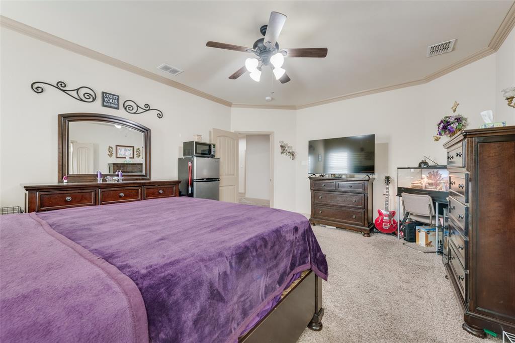 5056 Empire Way Irving, TX 75038 - Photo 24 of 40 a bedroom with a bed and a flat screen tv