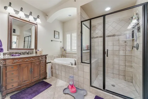 a bathroom with a double vanity sink mirror and shower