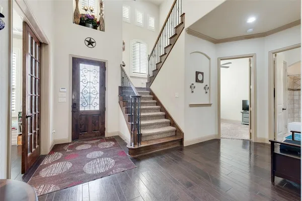 a view of entryway and hall with wooden floor