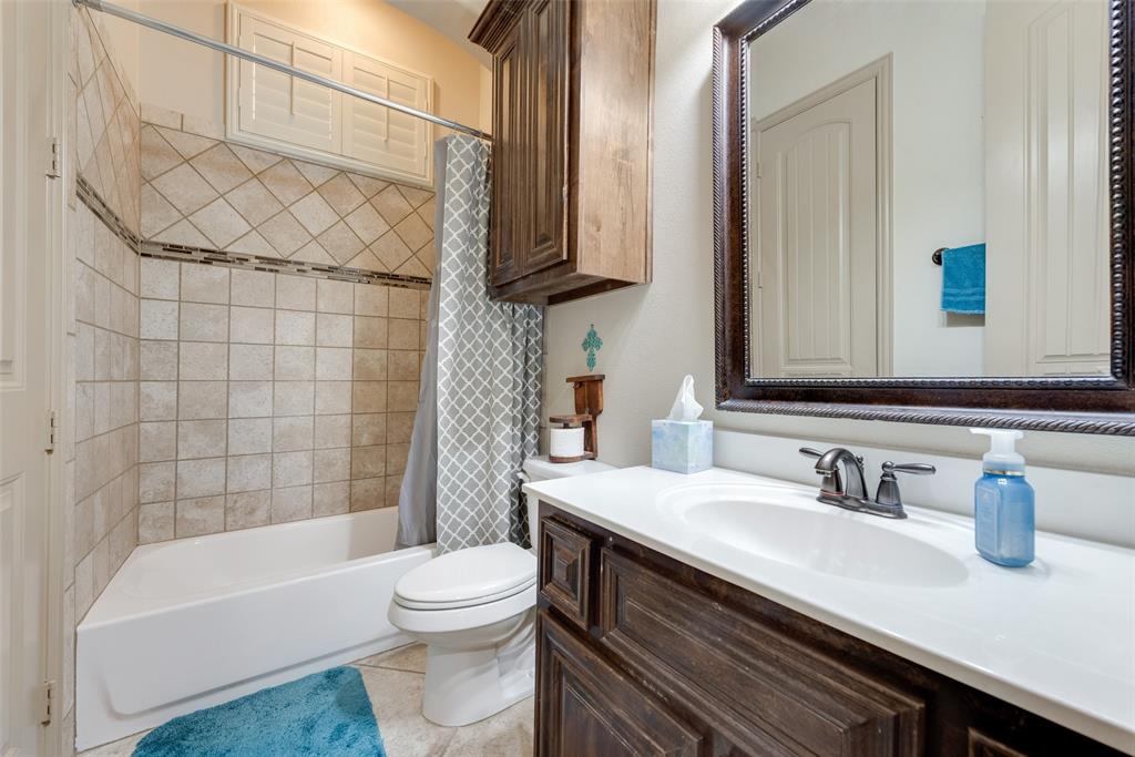 5056 Empire Way Irving, TX 75038 - Photo 6 of 40 a bathroom with a sink a toilet and shower
